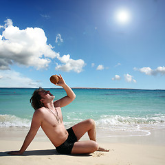 Image showing man on the island with coconut