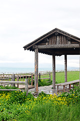 Image showing Wooden pavilion and fence in the grassland