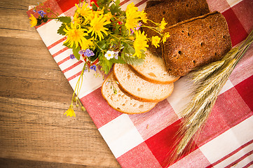 Image showing Still life with bread, flowers and spikes 