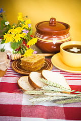 Image showing Still life with honeycombs, flowers and pot 