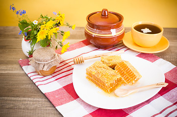 Image showing Still life with honeycombs, flowers and pot 