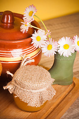 Image showing Still life with honey, flowers and pot 