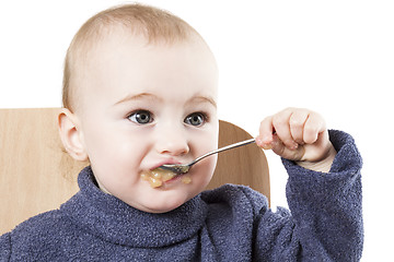 Image showing baby eating applesauce