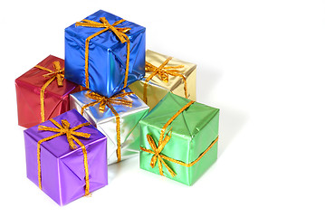 Image showing Six brightly colored wrapped Christmas packages