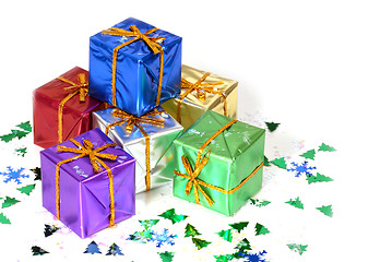 Image showing Six brightly colored wrapped Christmas presents