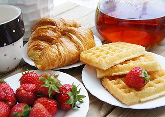 Image showing Tasty breakfast - tea, croissants, wafers with cream 