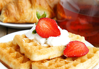 Image showing Tasty breakfast - tea, croissants and wafers