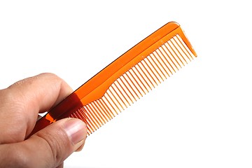 Image showing plain plastic comb in a human hand