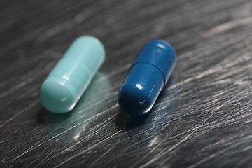 Image showing colored medicinical capsules on a steel plate