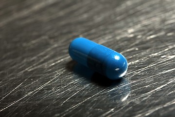 Image showing colored medicinical capsule on a steel plate