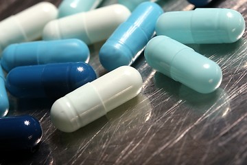 Image showing colored medicinical capsules on a steel plate