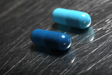 Image showing colored medicinical capsules on a steel plate