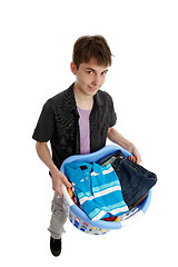 Image showing Teenager holding a basket of laundry