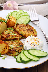 Image showing Zucchini Fritters and slices of new potatoes.