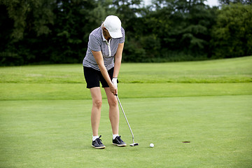 Image showing woman is playing golf on course  summer