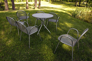 Image showing Chairs made of metal steel on meadow grass 