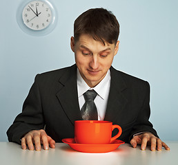 Image showing Businessman drinking a very strong and  hot coffee