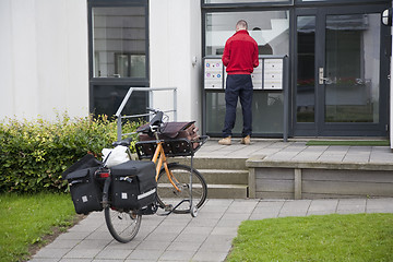 Image showing Postman distributing