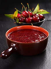 Image showing Homemade cherry jam with wild strawberries