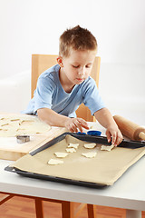 Image showing Small boy baking cookies
