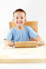 Image showing Small boy baking cookies