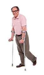 Image showing Smiling elderly man with crutches