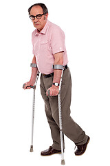 Image showing Depressed senior male with two crutches