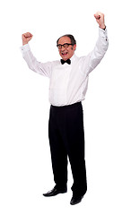 Image showing Excited senior man posing with raised arms