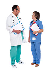 Image showing Male and female doctors discussing a case