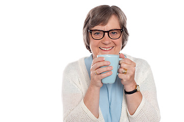 Image showing Smiling lady drinking hot coffee