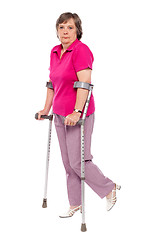 Image showing Unhappy handicapped woman with crutches