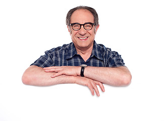 Image showing Smiling aged man posing with blank billboard