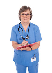 Image showing Smiling matured doctor writing prescription