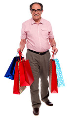 Image showing Happy matured man carrying shopping bags