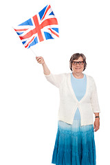 Image showing Senior lady holding UK flag and waving