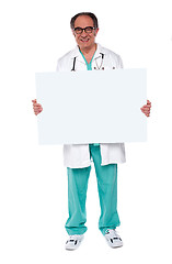 Image showing Confident doctor showing blank whiteboard