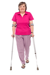 Image showing Full length portrait of an injured senior woman