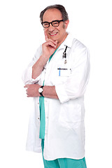 Image showing Senior male doctor posing against white