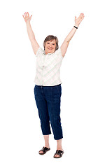 Image showing Cheerful senior woman lifting her arms up