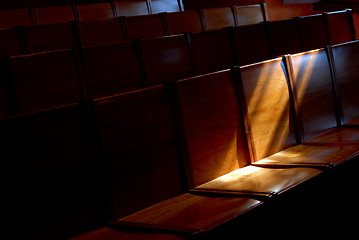 Image showing Rows of church pews with stream of light