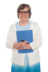 Image showing Happy aged woman holding notebook and pen