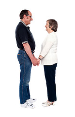 Image showing Aged couple looking at each other, holding hands