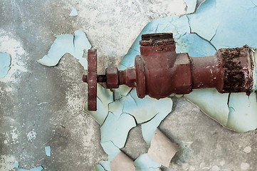 Image showing Rusty old tap against concrete wall