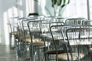 Image showing Photo of a canteen with metal chairs and tables