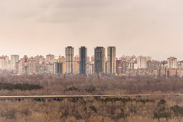 Image showing Tall buildings and forest