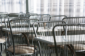 Image showing Photo of a canteen with metal chairs and tables