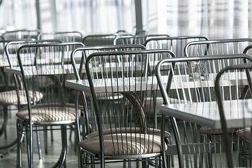 Image showing Photo of a canteen with metal chairs and tables