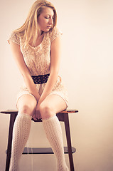 Image showing Young woman sitting on chair