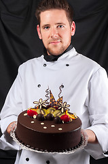 Image showing Handsome chef with cake
