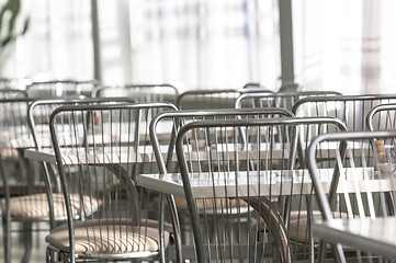 Image showing Photo of a canteen with metal chairs and tables